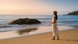 Asian Thai women walks at the beach during sunset in Khao Lak Thailand